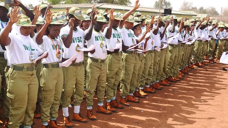 National Youth Services Corps Members, on the parade ground well decorated with khaki pants and white polo vest. Graphic design promoting the Mo Ibrahim Leadership Fellowship 2025 for African professionals, fully funded opportunity displayed with. In a swearing in excercise