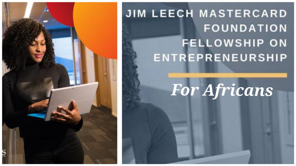 A young individual holding a laptop stands in a modern hallway, symbolizing the opportunities provided by the Jim Leech Mastercard Foundation Fellowship on Entrepreneurship for Africans. The fellowship aims to empower African entrepreneurs with the skills and resources needed to succeed